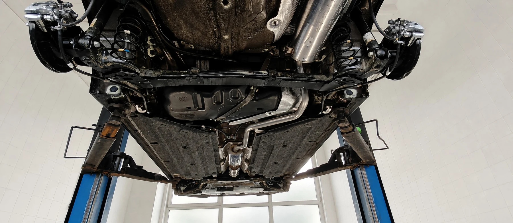 Unterboden nach Schutzauftrag und Abschlusskontrolle auf der Hebebühne bei Car Care Customs in Cham
